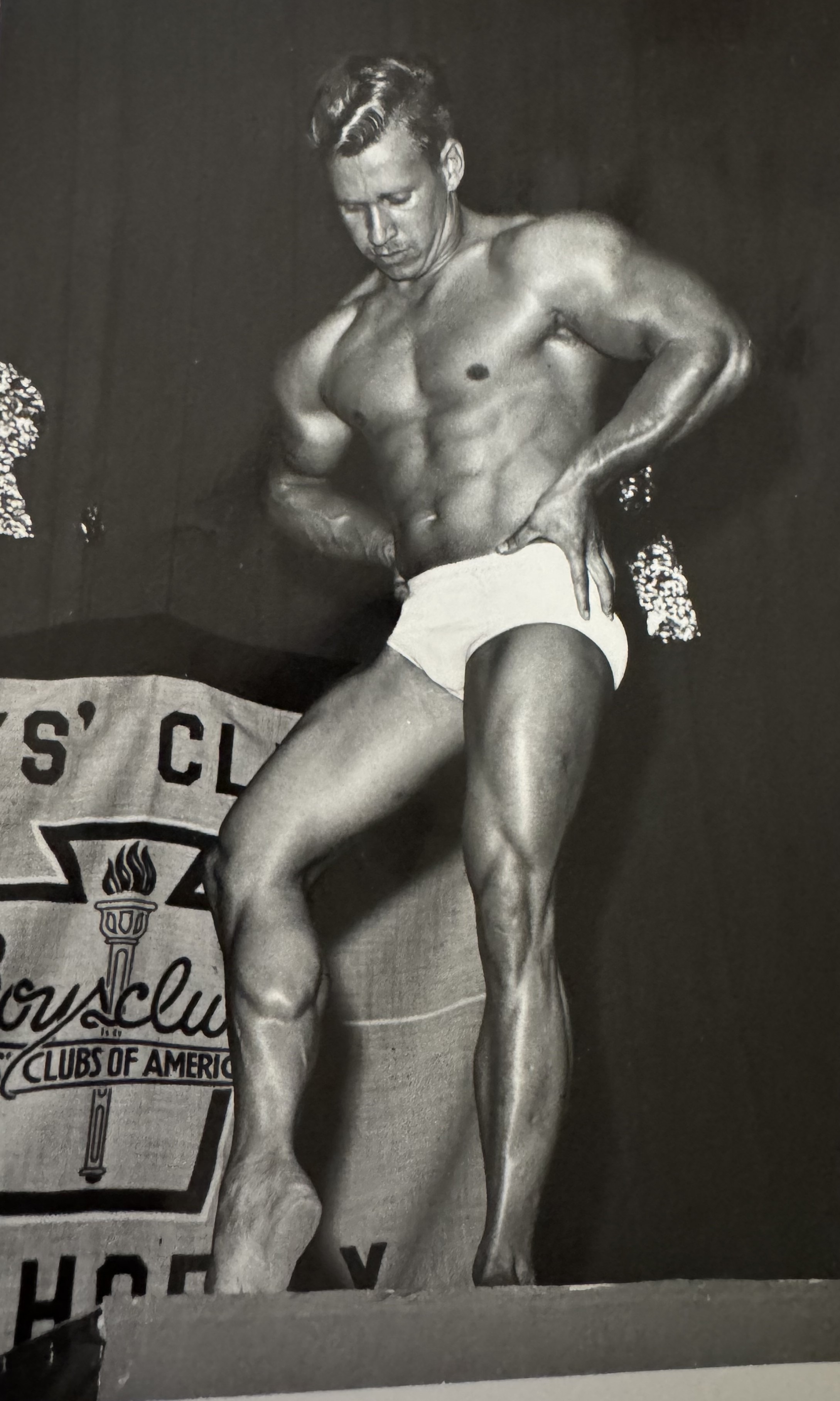 Gail Crick - double bicep pose on the Boys Club of Phoenix stage