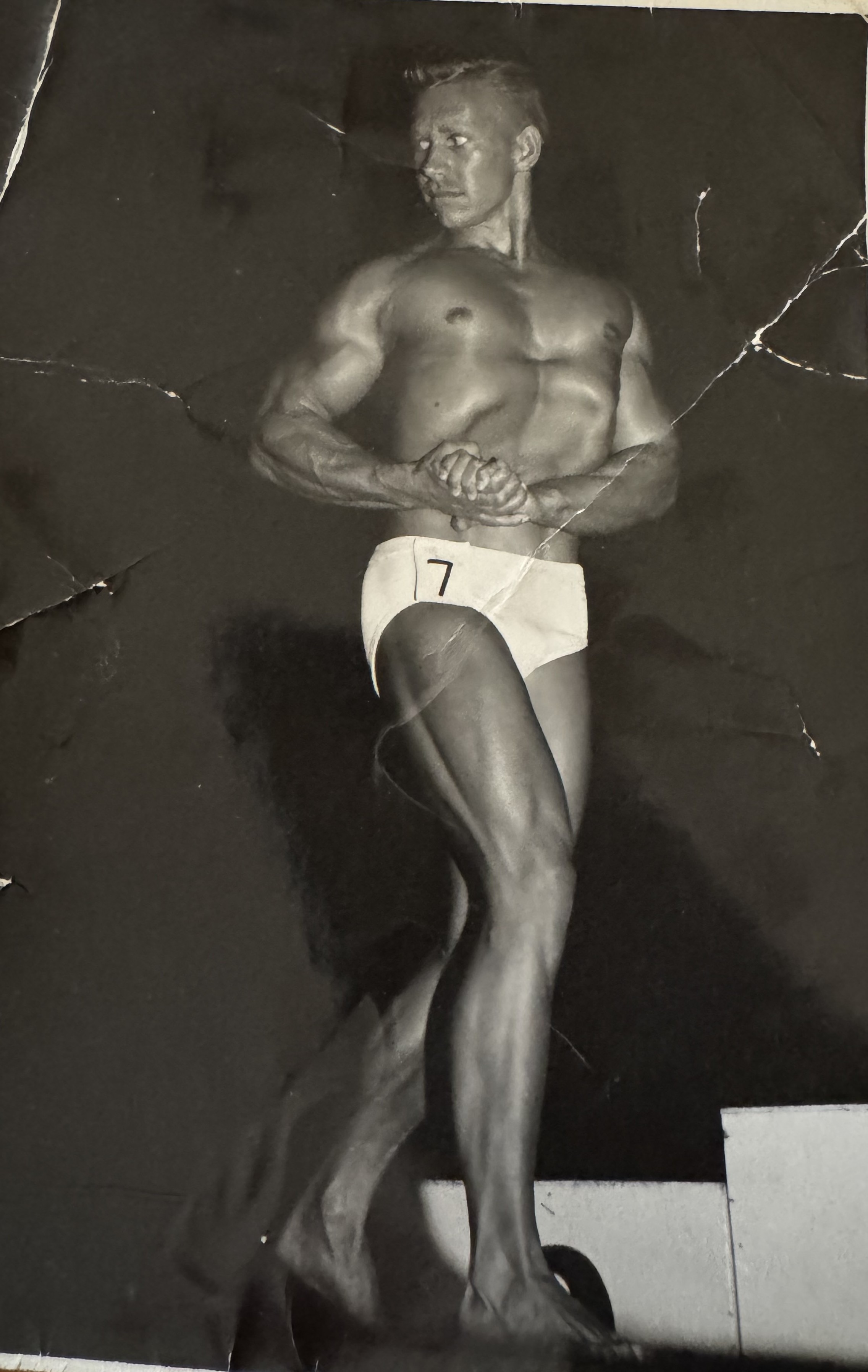 Gail Crick on stage at the 1961 Mr. America contest, wearing competitor number 7