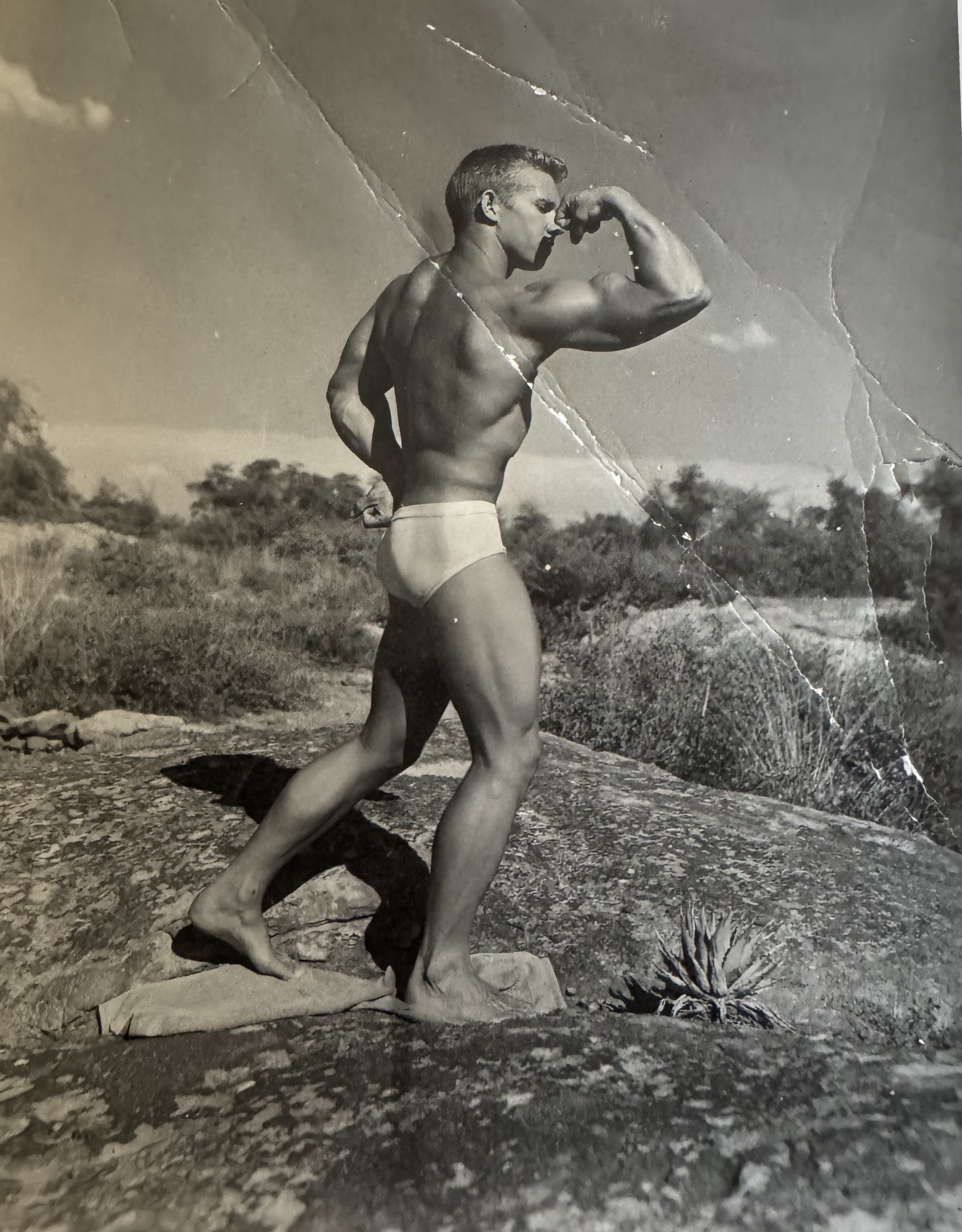 Gail Crick - outdoor double bicep pose on Arizona rock outcrop