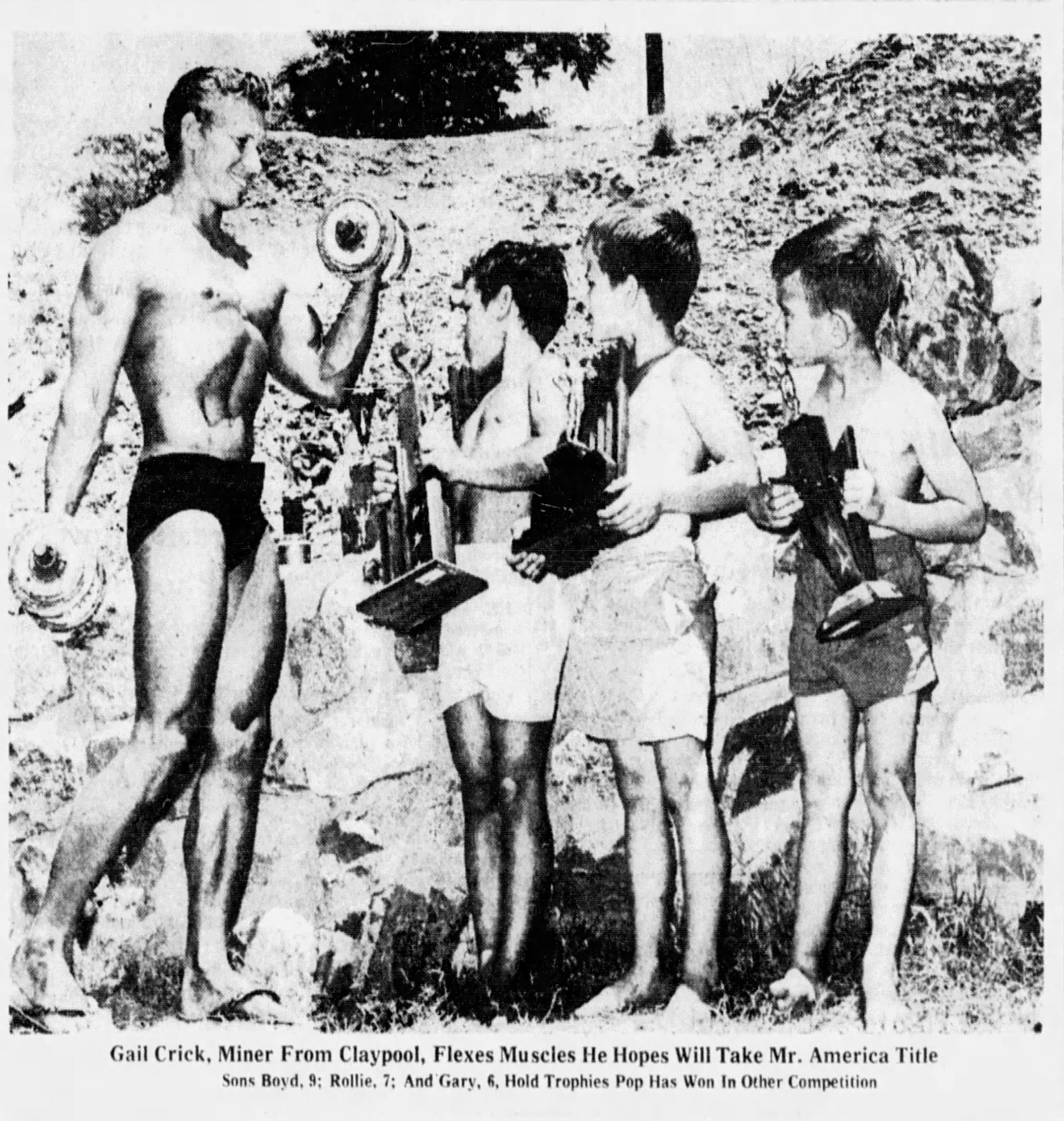 Gail Crick flexing with his sons before the Mr. America contest, 1961
